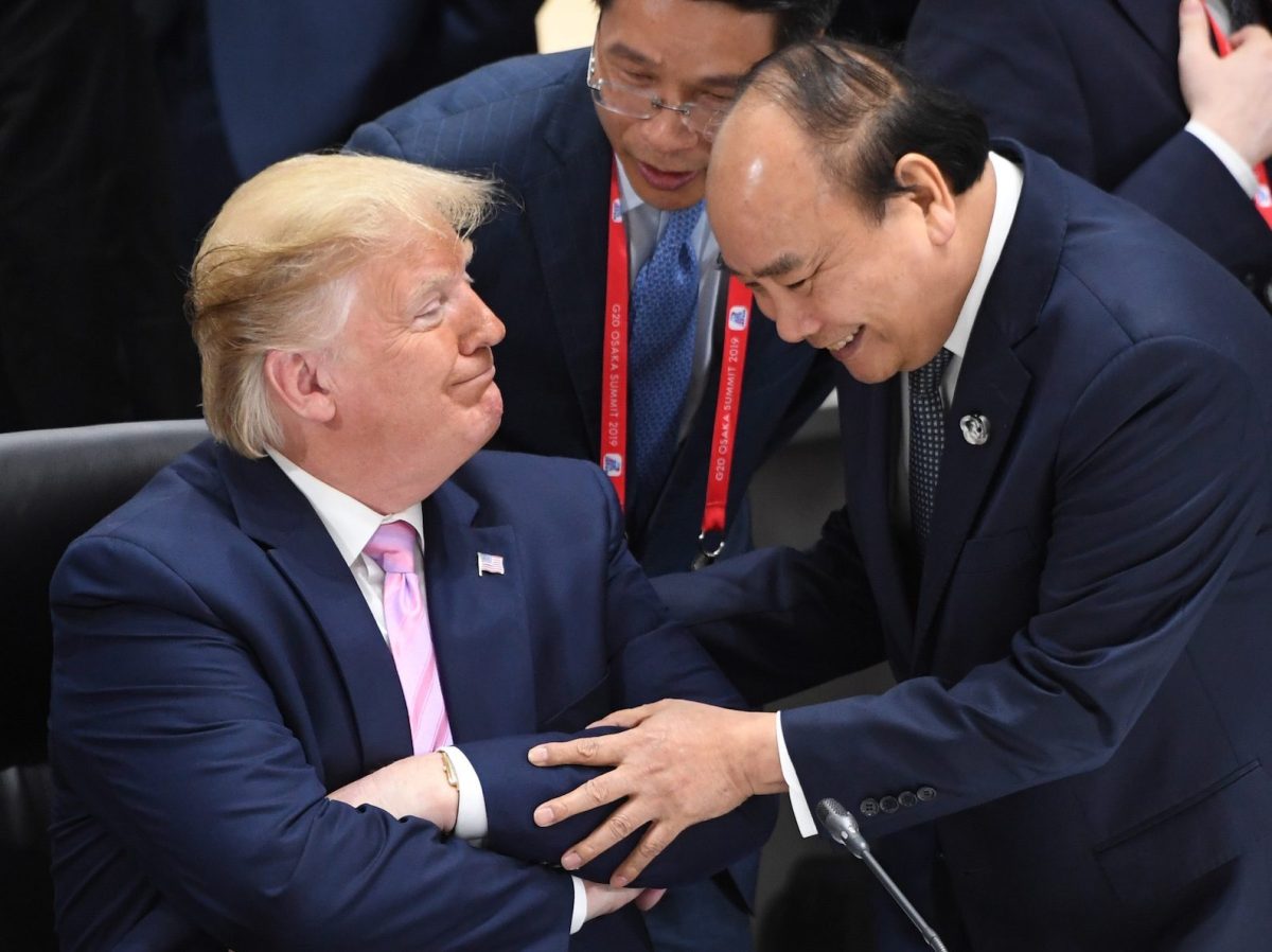 US President Donald Trump listens to Vietnam’s Prime Minister Nguyen Xuan Phuc at the G20 summit in Osaka, Japan, June 28, 2019. Photo: AFP via Sputnik/Iliya Pitalev